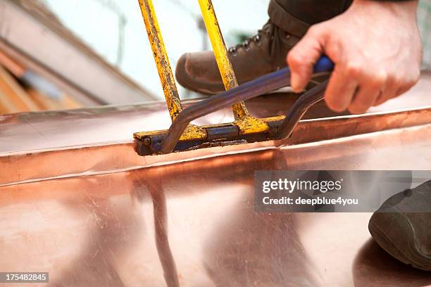 working roofer with copper - animal leg stockfoto's en -beelden