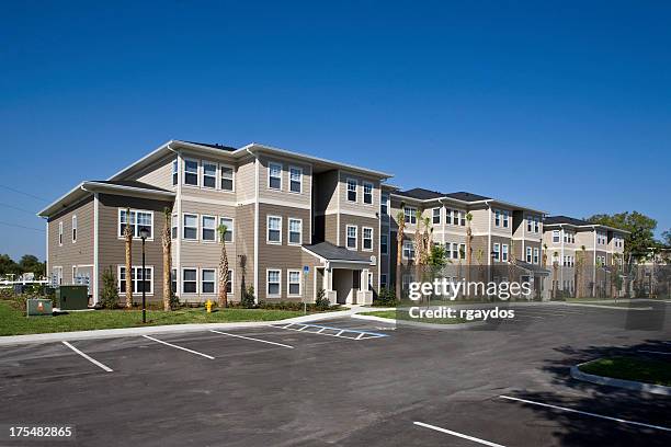 a landscape view of the exterior of a new apartment complex - suburban apartments stock pictures, royalty-free photos & images