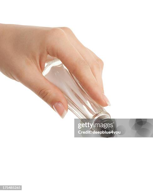 salt shaker in woman hand on white - strooisels stockfoto's en -beelden