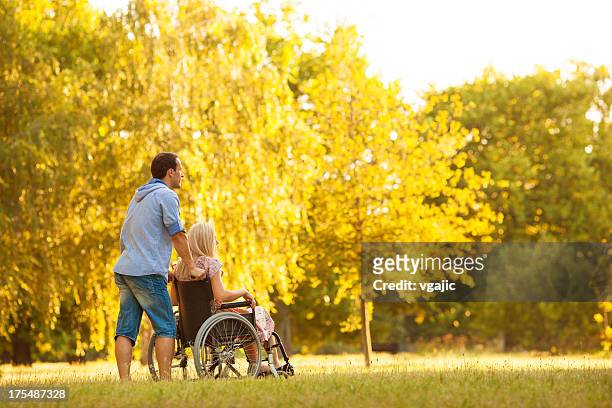 handicapped couple outdoors. - long hair stock pictures, royalty-free photos & images