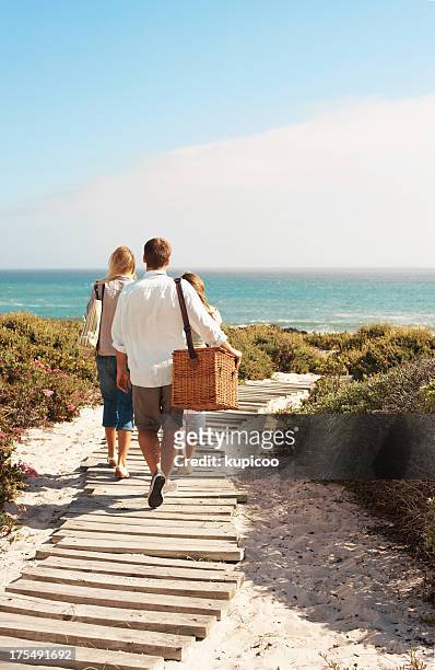 walking towards the sand and sea - beach picnic stock pictures, royalty-free photos & images