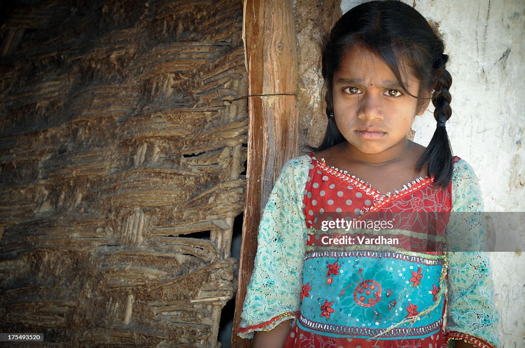 Young girl with pigtails, wearing rural clothes