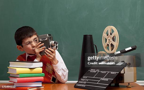 little boy learning how to make film via video camera - young film director stock pictures, royalty-free photos & images