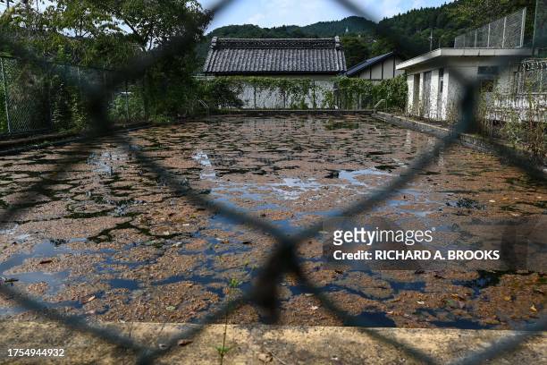 This photo taken on September 20, 2023 shows a swimming pool unused for years at the former Ashigakubo Elementary School in the town of Yokose, near...