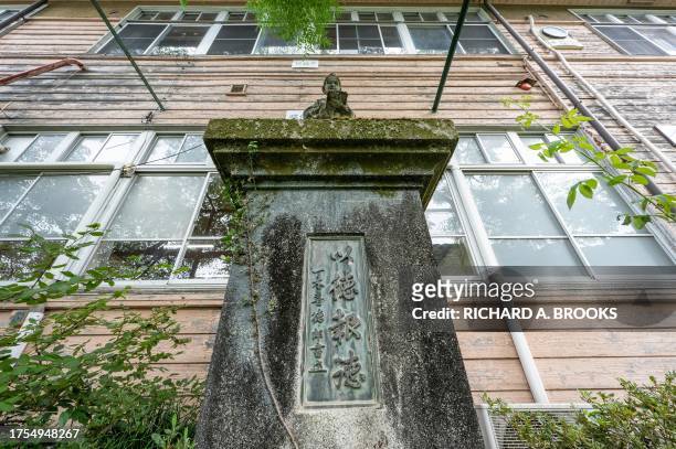 This photo taken on September 20, 2023 shows a statue at the front of main building of the former Ashigakubo Elementary School in the town of Yokose,...