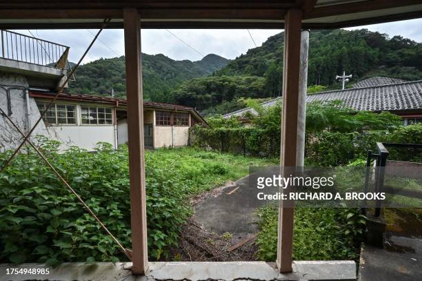 This photo taken on September 20, 2023 shows part of the overgrown grounds at the former Ashigakubo Elementary School in the town of Yokose, near...