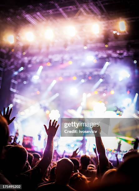 young people at a party dancing with their hands up - rock music festival stock pictures, royalty-free photos & images