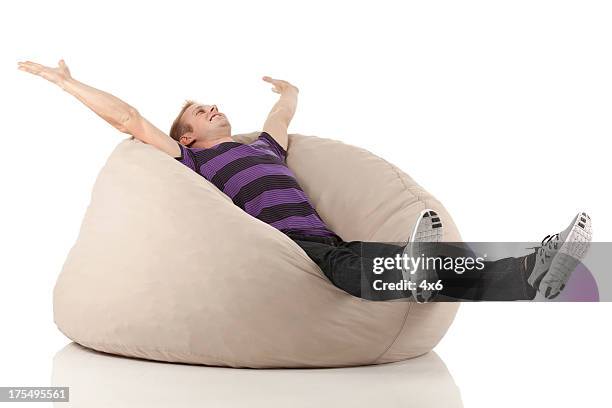 man relaxing on bean bag - bean bags stock pictures, royalty-free photos & images