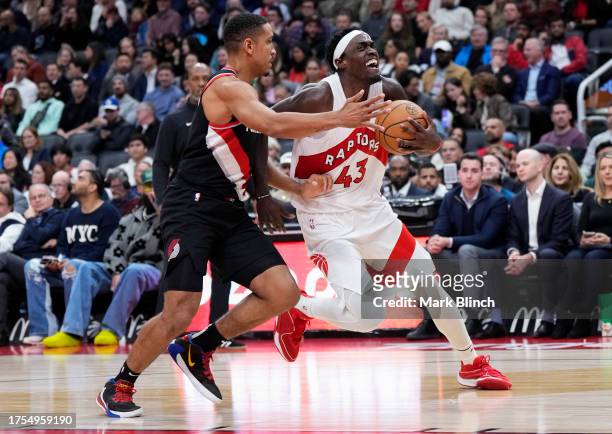 Pascal Siakam of the Toronto Raptors drives against Malcolm Brogdon of the Portland Trail Blazers during the second half at the Scotiabank Arena on...