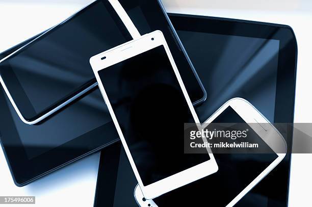 stack of mobile phones and tablets on a white background - large group of objects stock pictures, royalty-free photos & images