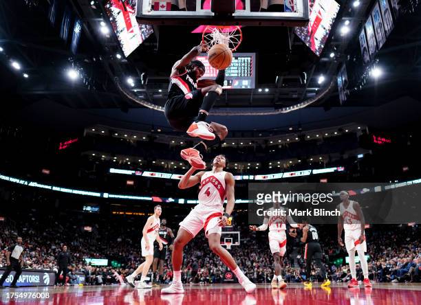 Jerami Grant of the Portland Trail Blazers dunks against Scottie Barnes of the Toronto Raptors during the second half of their basketball game at the...
