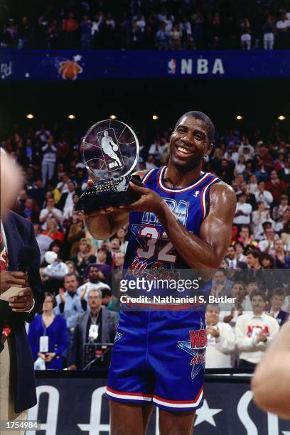 Magic Johnson of the Los Angeles Lakers poses with the All-Star MVP Trophy during the 1992 NBA All-Star Game at the Orlando Arena on February 9, 1992...
