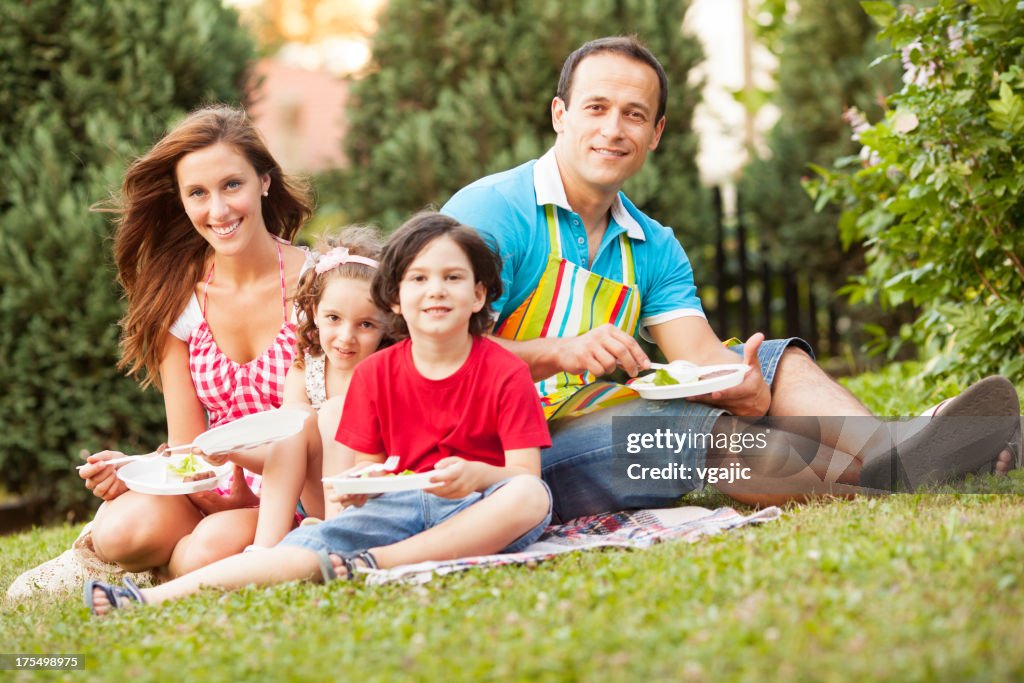 Families enjoying barbecue outdoors