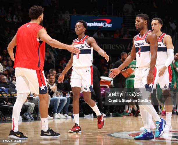 Bilal Coulibaly and Jared Butler of the Washington Wizards high five teammates during the game against the Boston Celtics on October 30, 2023 at...