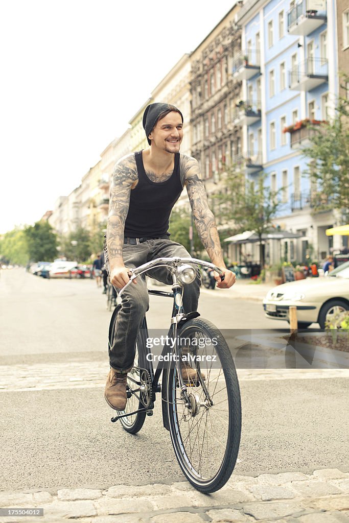 Young cyclist with tattoos in Berlin
