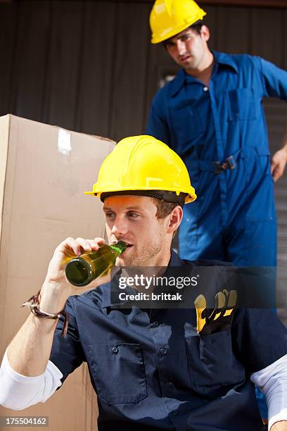 construction worker having a beer while the foreman watches chritically - beer helmet stock pictures, royalty-free photos & images