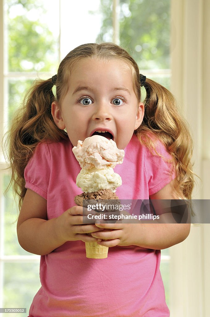 Cute Young Girl Eating a Triple Decker Ice Cream Cone
