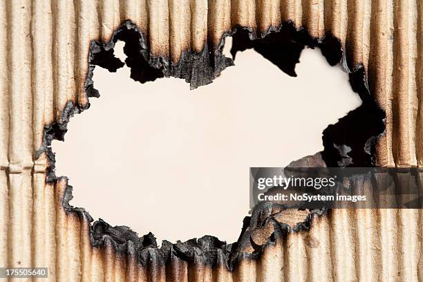 burned hole in cardboard - burning coal stock pictures, royalty-free photos & images