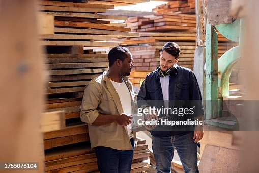 Workers talking on their coffee break at a lumberyard