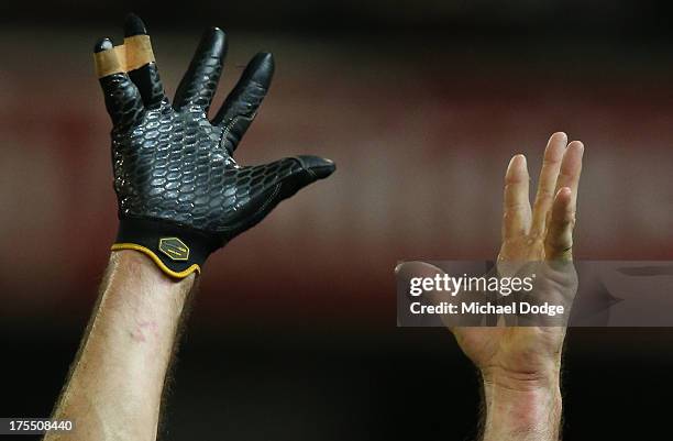 The hands of Quinten Lynch of the Magpies reach up for a mark during the round 19 AFL match between the Collingwood Magpies and the Essendon Bombers...