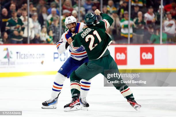 Brandon Duhaime of the Minnesota Wild and Evander Kane of the Edmonton Oilers fight in the first period at Xcel Energy Center on October 24, 2023 in...