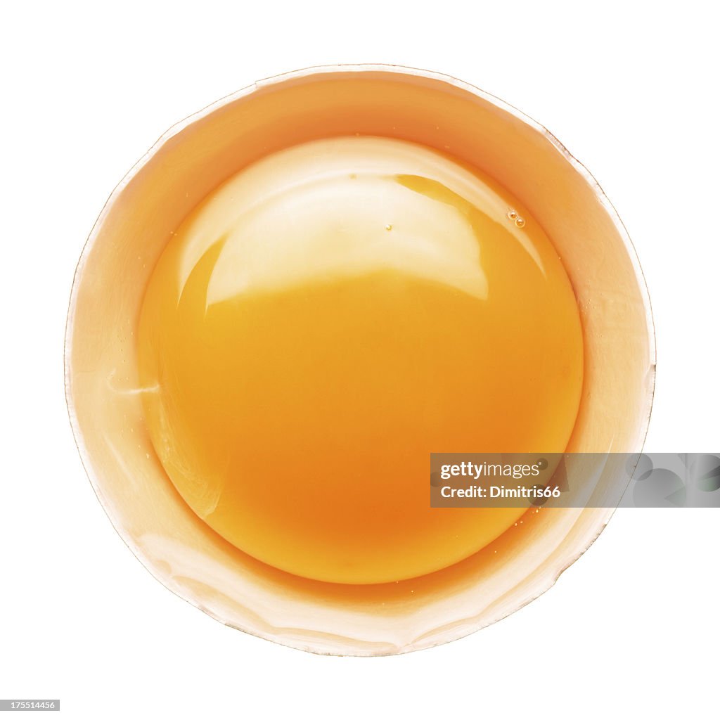 Fresh broken egg portion on white