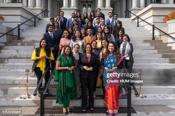 Vice President Kamala Harris, joined by White House staff, poses for a group photo in celebration of Diwali, Thursday November 4 on the Navy Steps of...