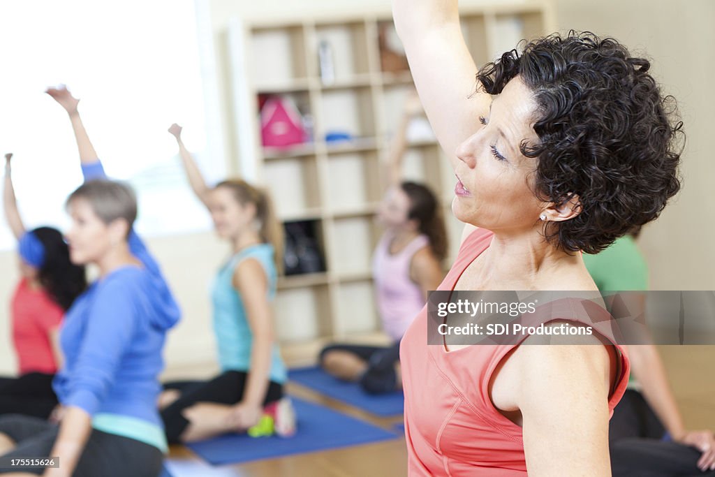 Fitness class of women doing stretching exercises