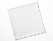 Isolated shot of folded white napkin on white background
