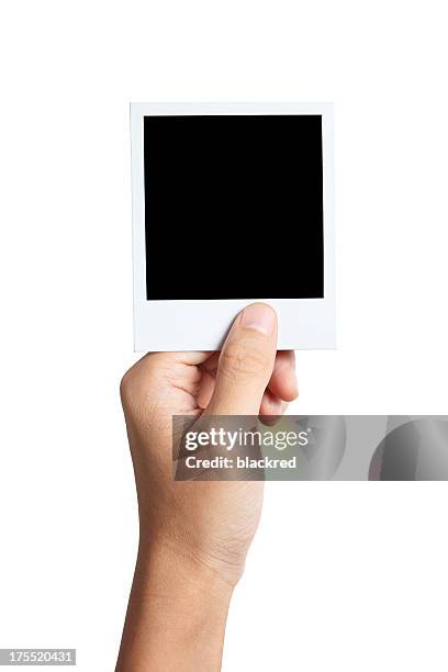 hand holding instant photo - human hand photos stock pictures, royalty-free photos & images