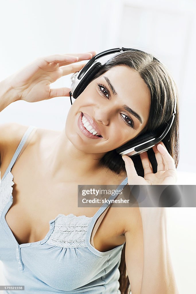 Smiling young woman listening a music.