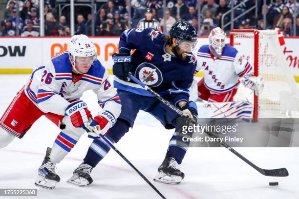 Alex Iafallo of the Winnipeg Jets plays the puck down the ice as Jimmy Vesey of the New York Rangers gives chase during third period action at the...