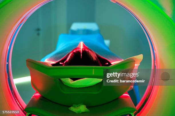 patient laying on a ct scan platform - oncology bildbanksfoton och bilder