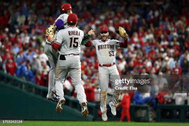 Ketel Marte, Emmanuel Rivera and Christian Walker of the Arizona Diamondbacks celebrate after beating the Philadelphia Phillies 4-2 in Game Seven of...