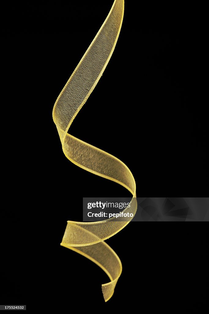 Transparent gold ribbon against black background
