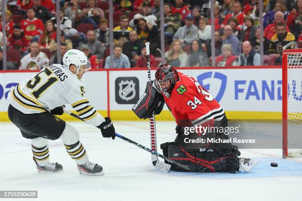 Matthew Poitras of the Boston Bruins scores a goal past Petr Mrazek of the Chicago Blackhawks during the third period at the United Center on October...