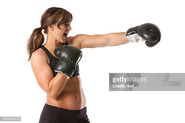 weibliche boxer in aktion - boxing gloves isolated stock-fotos und bilder