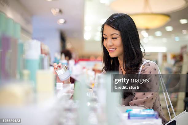 choosing cosmetics - beauty shopping stockfoto's en -beelden
