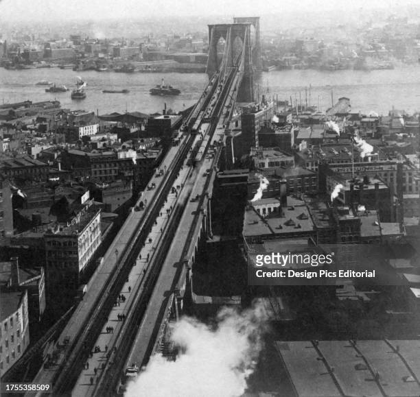 Historic image in black and white of the Brooklyn Bridge over the East River in New York City, circa 1902; New York City, New York, United States of...