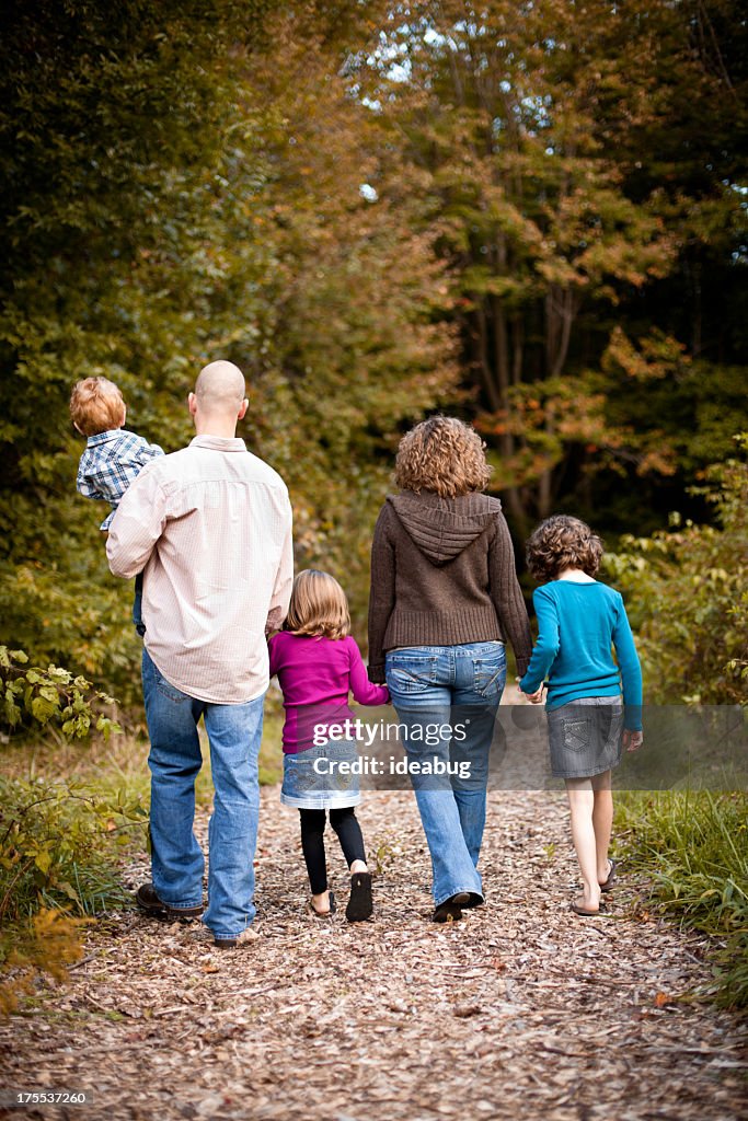 Family with Father, Mother, Daughters, and Son Walking in Woods