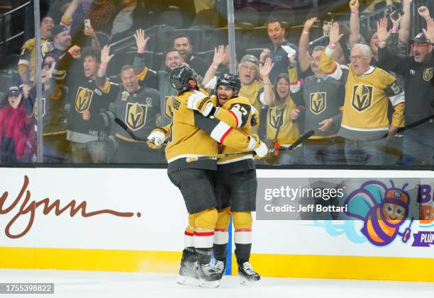 Shea Theodore of the Vegas Golden Knights celebrates with teammates after scoring the game-winning goal during the third period against the...