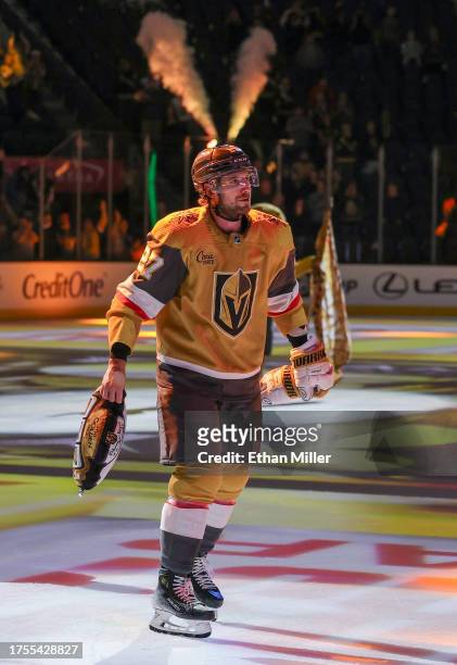 Shea Theodore of the Vegas Golden Knights prepares to throw a slot machine-themed pillow to fans after being named the first star of the game...