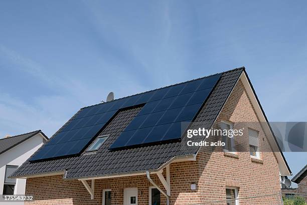 new basic house with solar panels on the roof - roof tiles stock pictures, royalty-free photos & images