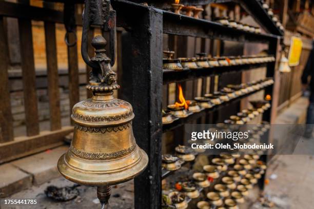 close up of bell and lit candles in buddhist temple in kathmandu - tibet stock pictures, royalty-free photos & images