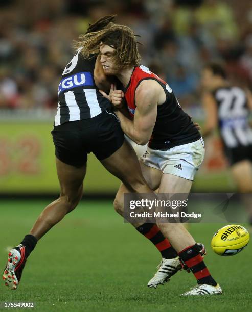 Harry O'Brien of the Magpies and Nick Kommer of the Bombers contest for the ball during the round 19 AFL match between the Collingwood Magpies and...