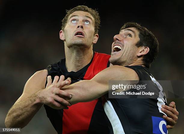 Tom Bellchambers of the Bombers and Quinten Lynch of the Magpies contest for the ball during the round 19 AFL match between the Collingwood Magpies...