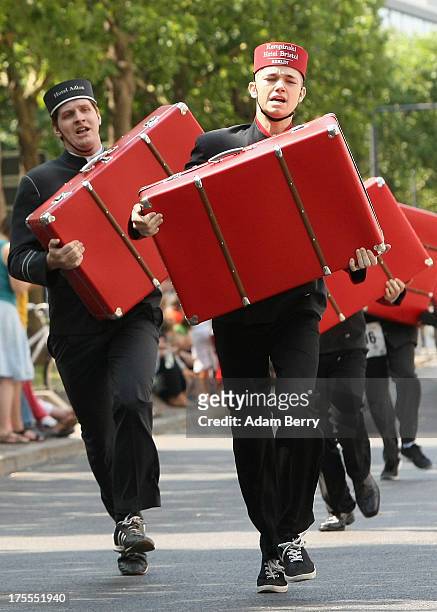 Hotel porters run with suitcases during the Waiters' Derby on August 4, 2013 in Berlin, Germany. At the annual event, brought back into existence in...
