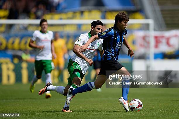 Mehmet Ekici of Werder Bremen chases Raffael Korte of FC Saarbruecken during the DFB Cup first round match between 1. FC Saarbrücken and Werder...