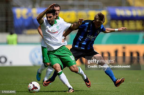 Mehmet Ekici of Werder Bremen chases Raffael Korte of FC Saarbruecken during the DFB Cup first round match between 1. FC Saarbrücken and Werder...