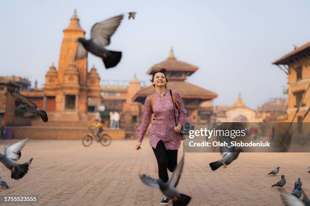 woman with camera exploring bhaktapur - public building stock pictures, royalty-free photos & images
